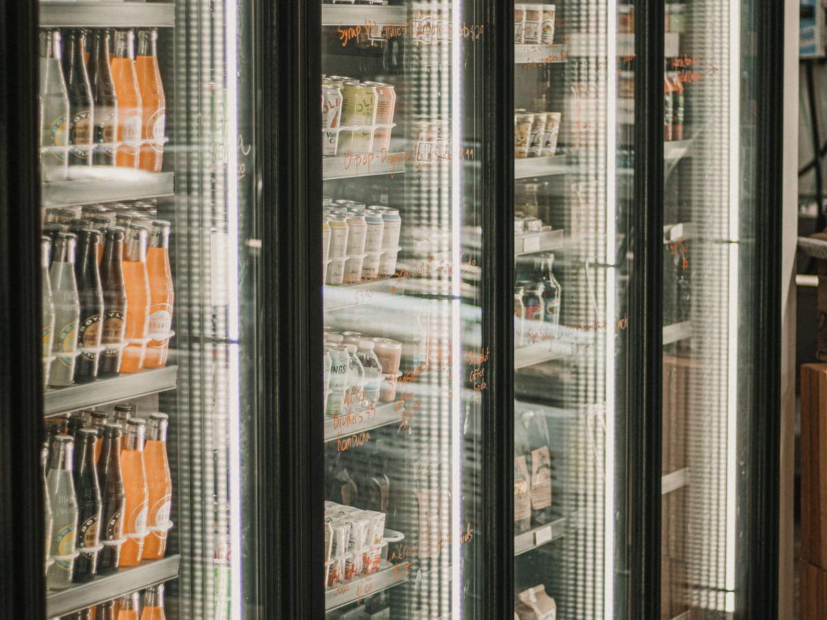 Refrigerated deli and beverage section in a brightly lit grocery store