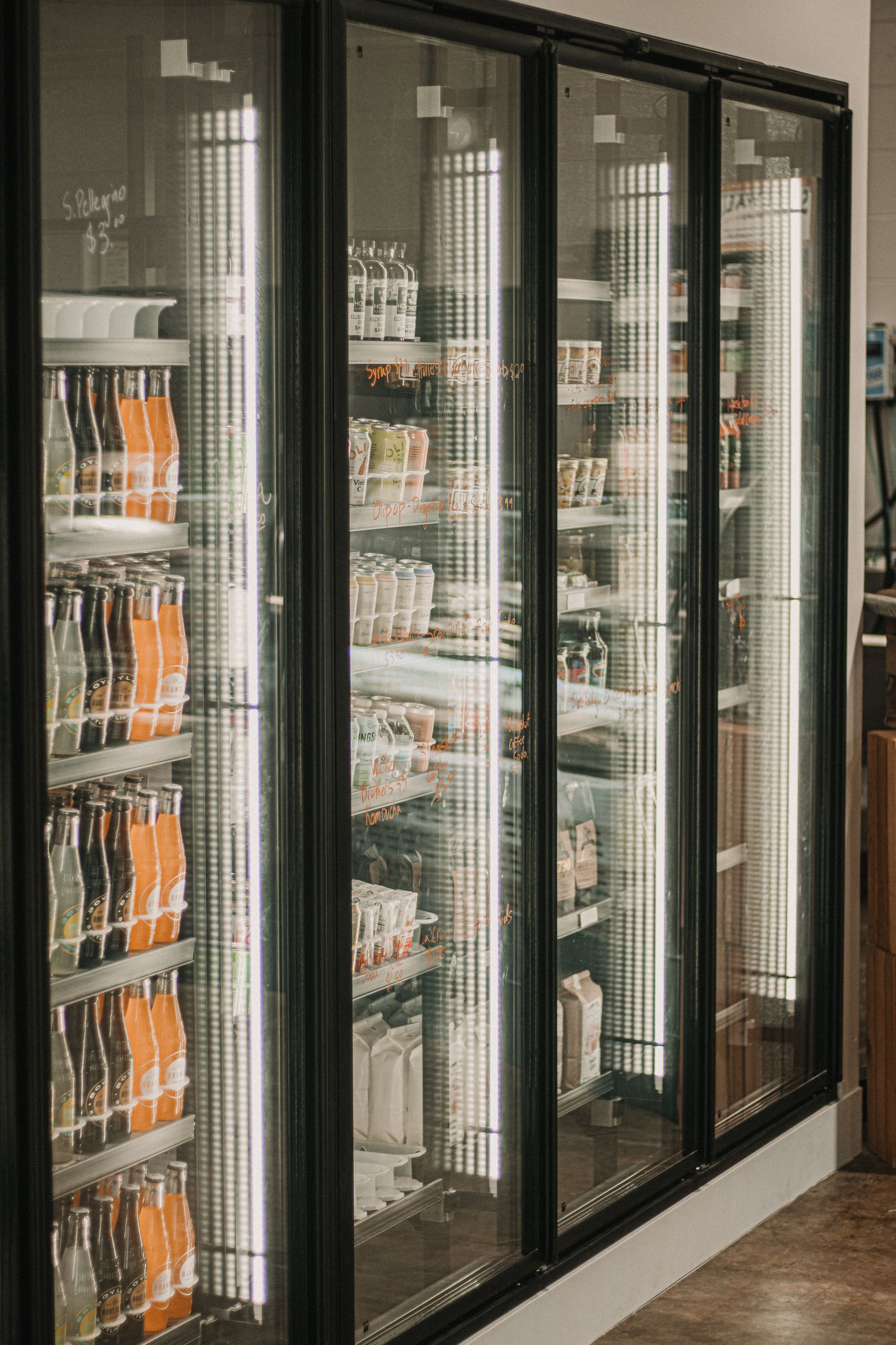 Refrigerated deli and beverage section in a brightly lit grocery store