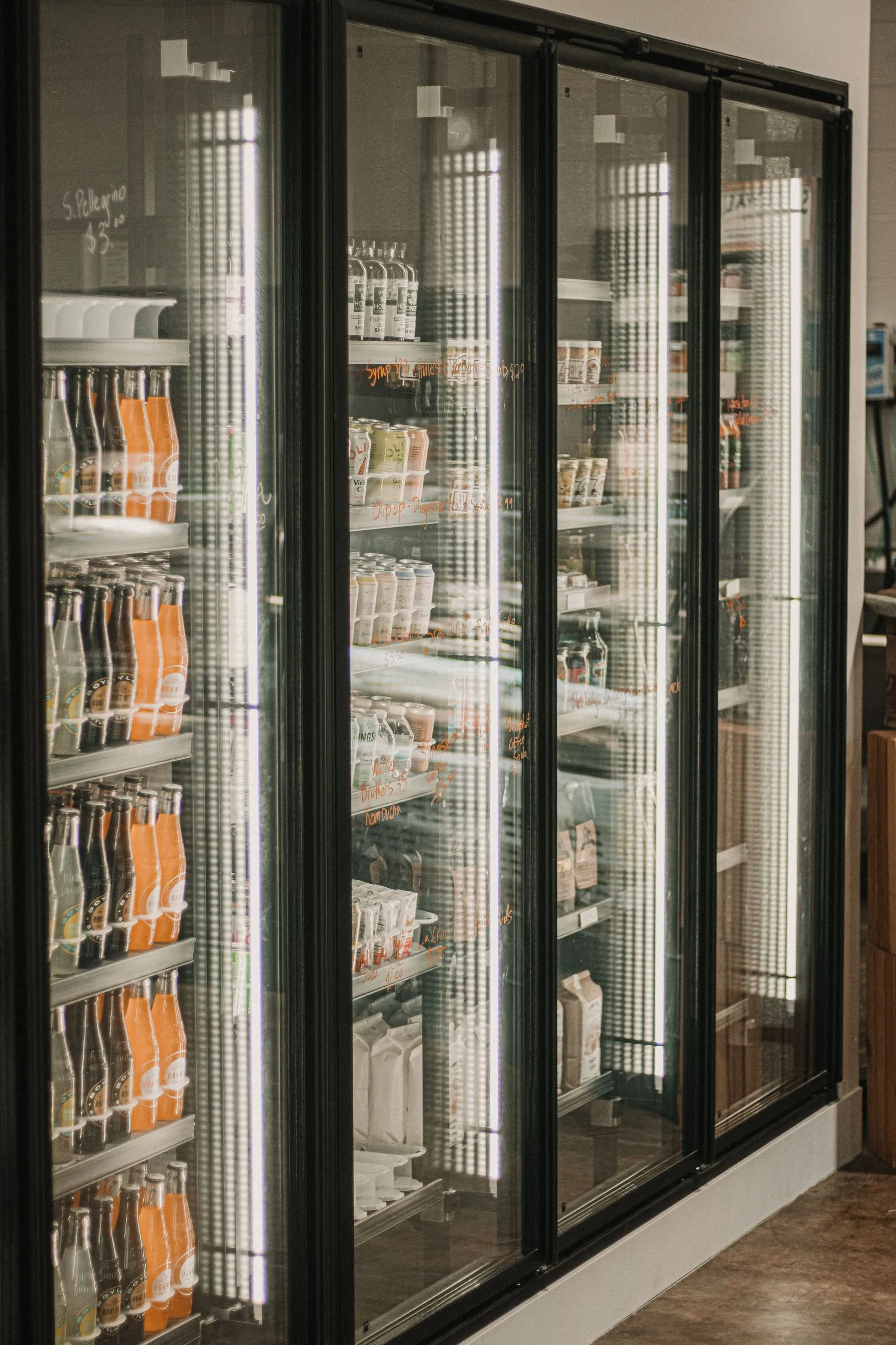 Refrigerated deli and beverage section in a brightly lit grocery store