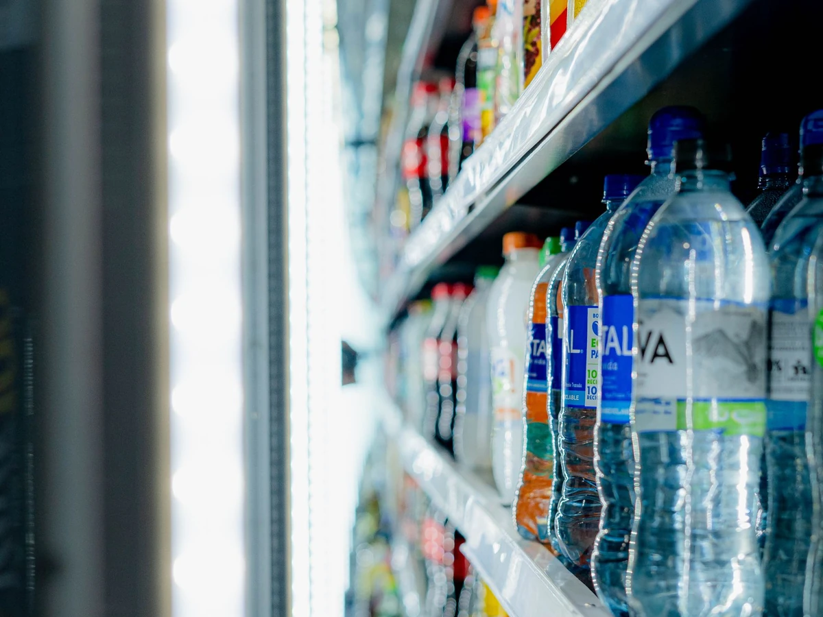 Chilled beverages arranged in a refrigerated grocery store display cooler